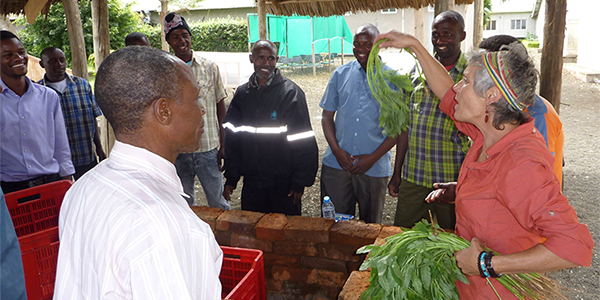 Woman showing agricultural products to a group of colleagues